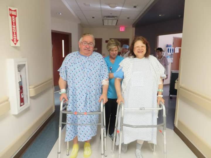 Ed Gracia walks with his wife, Carmen Gracia, following her partial knee replacement. Carmen Gracia was assisted by physical therapy clinical coordinator Susan Stradling. 
