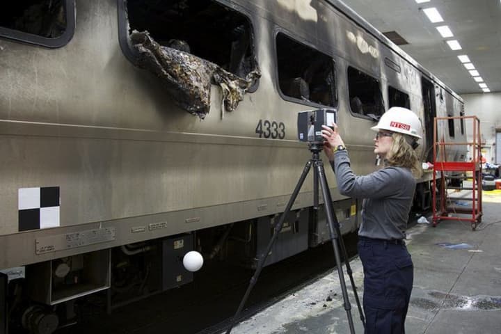 National Transportation Safety Board investigator Kristin Poland sets up 3D Laser Scanner to create model of the damaged rail car.