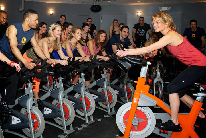 Rhodie Lorenz leads an indoor cycling class at JoyRide in Darien.