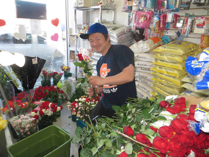 Hidenori Takada, owner of Oishinbo Japanese Grocery in Harrison, preparing roses for Valentine&#x27;s Day.