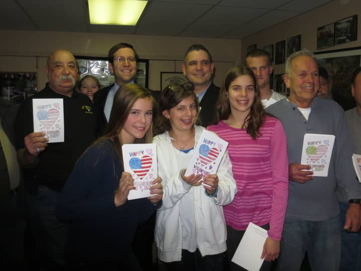 Middle school students from Byram Hills -- Caroline Kelly, Emily Ragals and Arielle Ragals -- distributed handmade valentines to Harrison veterans including Joe Mazzullo, far left. Assemblyman David Buchwald is next to Mazzullo. 