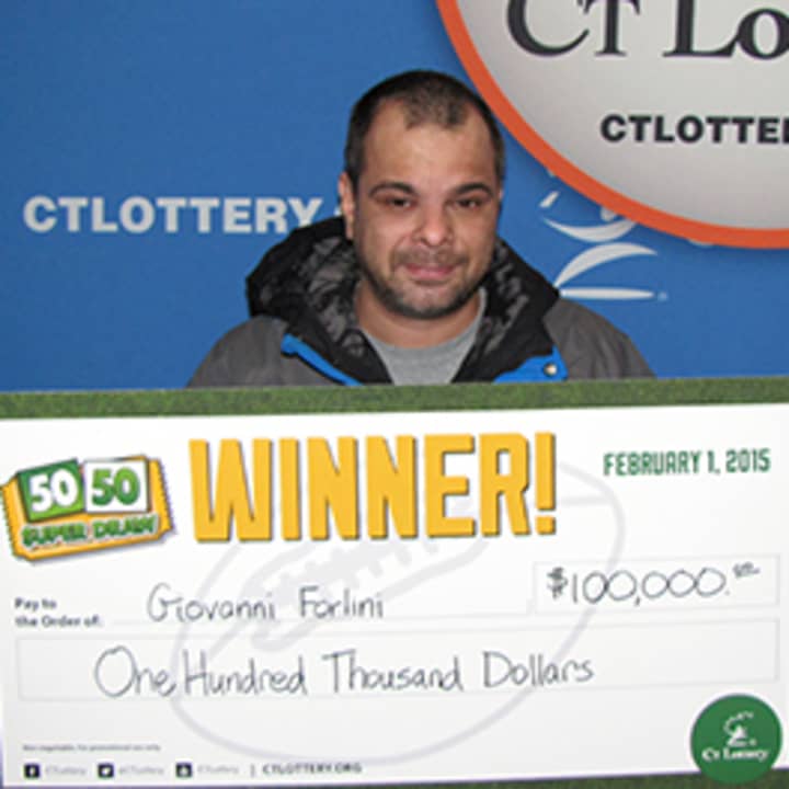 Giovanni Forlini with his ceremonial  $100,000 check.