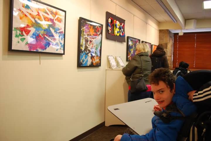 Pines Bridge student Perry McNiff of Rye Neck visits the Katonah Village library to see some of the paintings he and other Pines Bridge students had created. 