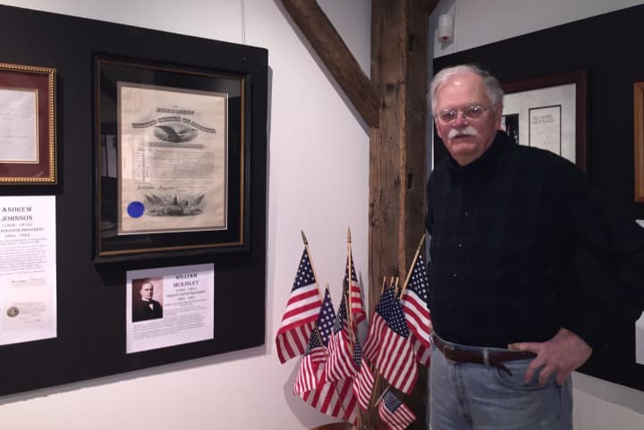 Darien Historical Society Historian Ken Reiss with some of the presidential signatures in the exhibit &quot;Signed by the President&quot;