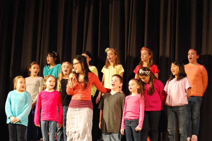 Students from Anne Hutchinson School and Greenvale School were joined by Broadway performer Olivia Oguma in song. 
