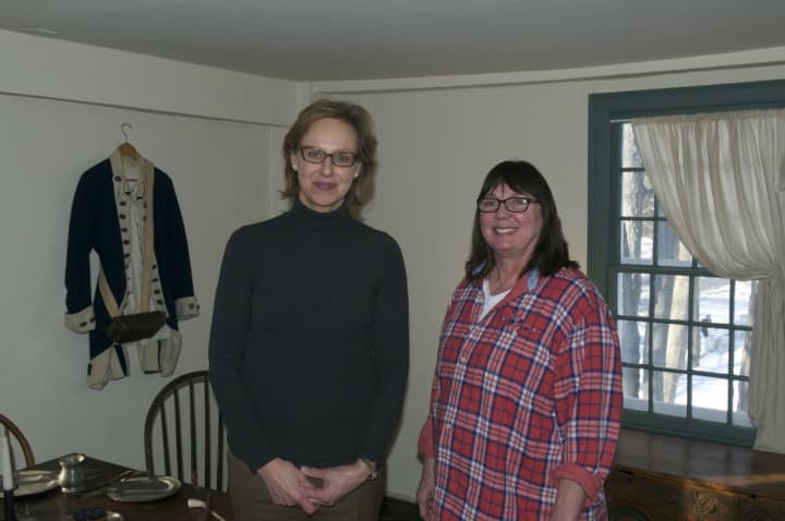 Hildi Grob, left, the executive director of Keeler Tavern Museum, and Erika Askin, Collections Curator, stand in the Assembly Room.