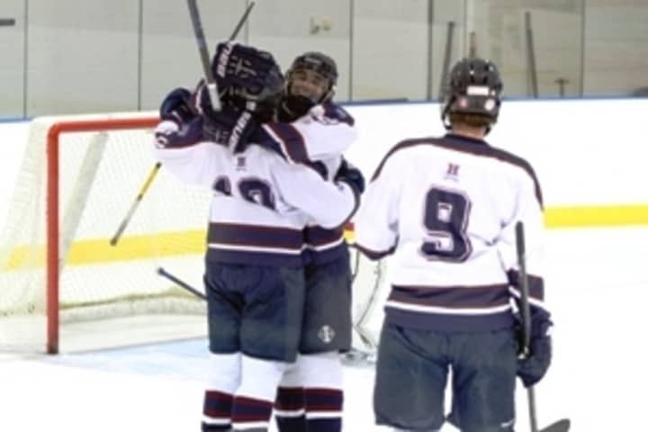 Harvey&#x27;s Keith Lambert celebrates with teammates after scoring against Forman. The senior from Cortlandt Manor became the first Harvey hockey player to surpass 100 points for a season.