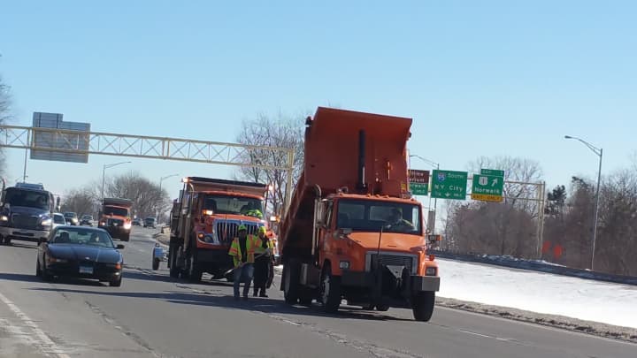 Construction workers shut down two lanes of traffic on Route 7 in Norwalk on Wednesday, while fixing potholes on the three-lane highway.