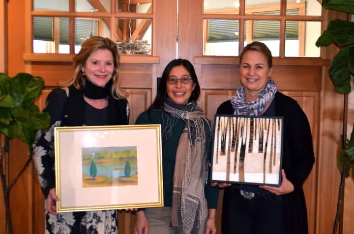 Pictured are TCD board members Carol Barr Matton, Sabina Harris and  Darien Nature Center Executive Director Elizabeth Hearle, holding donated artwork by Lisa Thoren and Meg Tweedy. Carol Barr Matton, Donna Collins and Mary Morant also contributed.