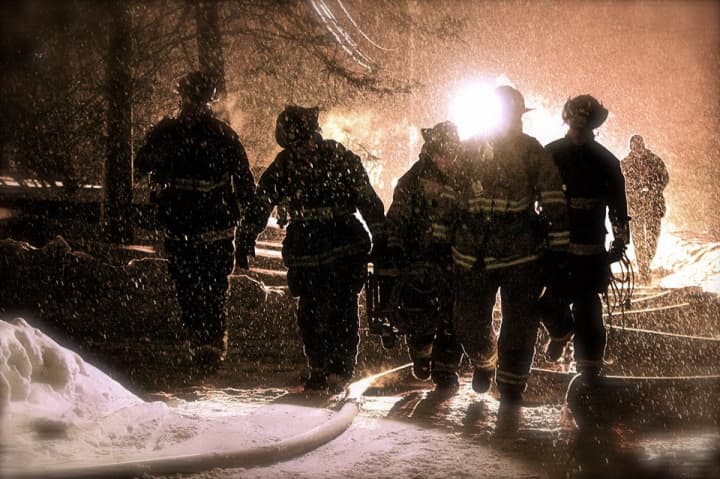 Westport firefighters fight a blaze at a home on Weathervane Hill Wednesday night.