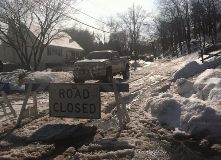 A portion of Adelphia Avenue in Harrison, N.Y., is closed to traffic where a recently retired White Plains police officer is alleged to have shot to death his two teenaged daughters and then killed himself Saturday.