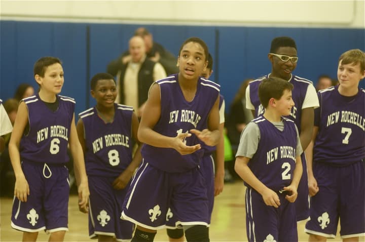 New Rochelle players walk off happy after Dylan Farley (12) hit the game-winning shot.