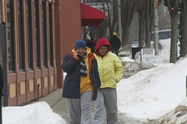 Pedestrians in Danbury bundle up to contend with the record-breaking cold temperatures the area has seen.