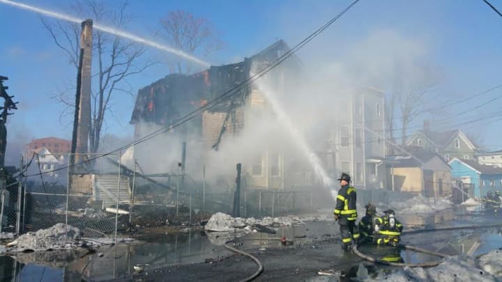Bridgeport firefighters continue to battle the blaze on Hanover Street on Friday. 
