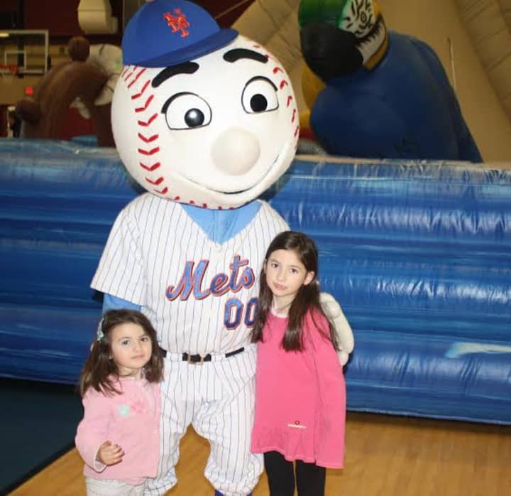 The Lazzaro sisters, Aoife, left, and Maeve, of Carmel, pose with Mr. Met, who made a special appearance at the Children&#x27;s Carnival for Charity at The Harvey School on Saturday.