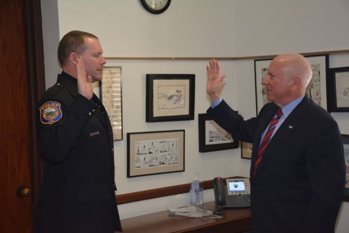 First Selectman Jim Marpe (right) swears in Officer Charles J. Sampson (left) on the morning of Monday, March 2.