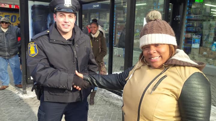 Yonkers Police Officer John Mucilli from the 4th Precinct shaking hands with a resident in Downtown Yonkers after the initiative was announced by Mayor Spano. 
 