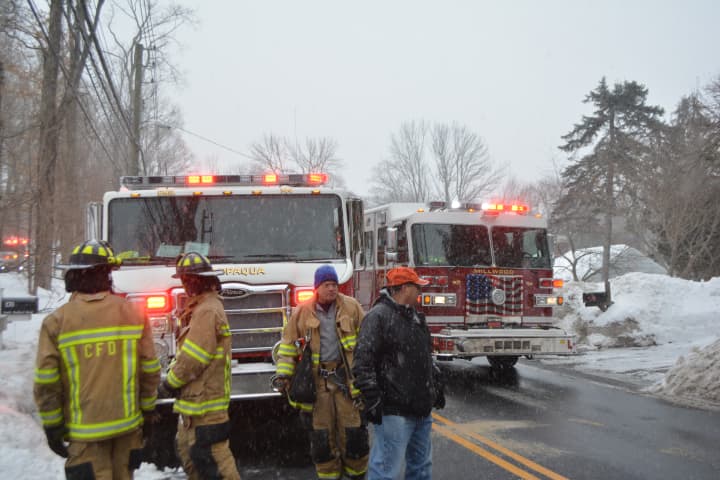 Firefighters near site of a home fire in Chappaqua. Firetrucks from Chappaqua and Millwood are pictured on Route 117.