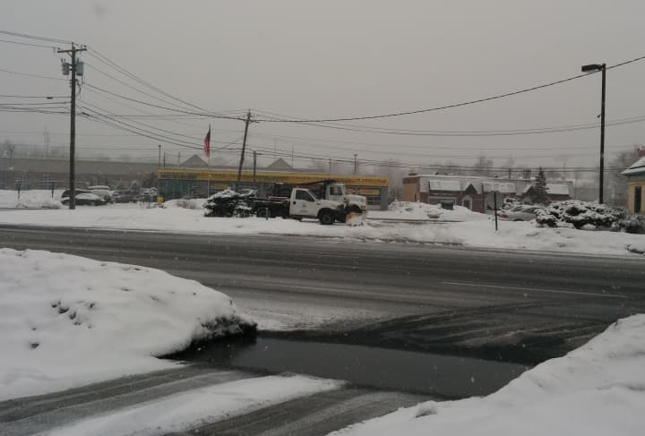 A salt truck and snowplow wait for conditions that demand their use in the Senior Salsa parking lot on Post Road in Fairfield.