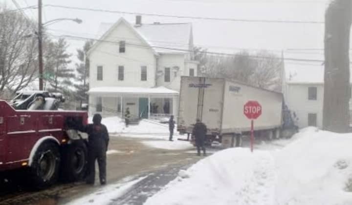 The truck is slowly towed from the intersection of Grand Street, Wilson Street and South Street at about 8:30 a.m. Thursday. 
