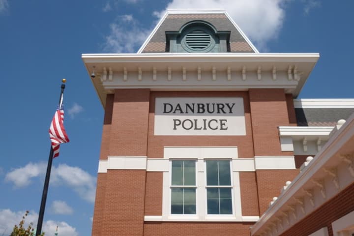 Two Danbury men were arrested after police said they broke into a car outside the police station.
