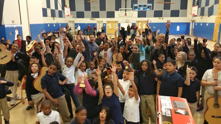 Students at Bridgeport&#x27;s Roosevelt School show off the donation of musical instruments. 