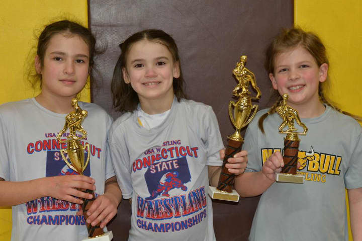 Mariana Hernandez, Calli Gilchrist,  and Rylee Donahue won trophies at the recent state championships for the Norwalk Mad Bulls wrestling team.