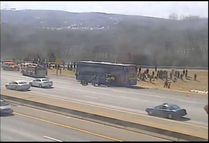 A bus is parked on the shoulder of I-84 westbound in Danbury near Exit 4. It appears to have been evacuated. 