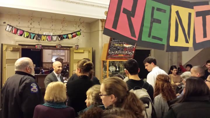 Josh Tenzer, drama coach and special education teacher at Port Chester High School, greets parents Thursday evening streaming into the opening night of &quot;Rent.&quot;