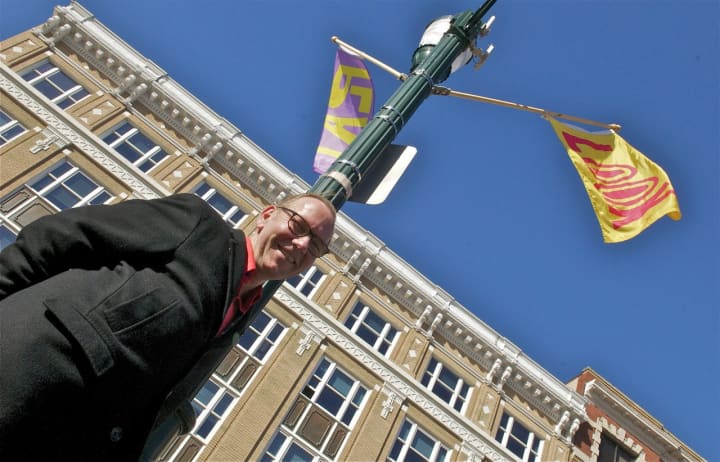 Jon Campbell with some of his banners near Main Street in Stamford.