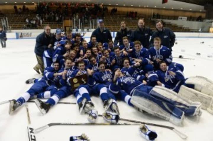 Darien High School hockey players celebrate after defeating Greenwich for the Division I state title.