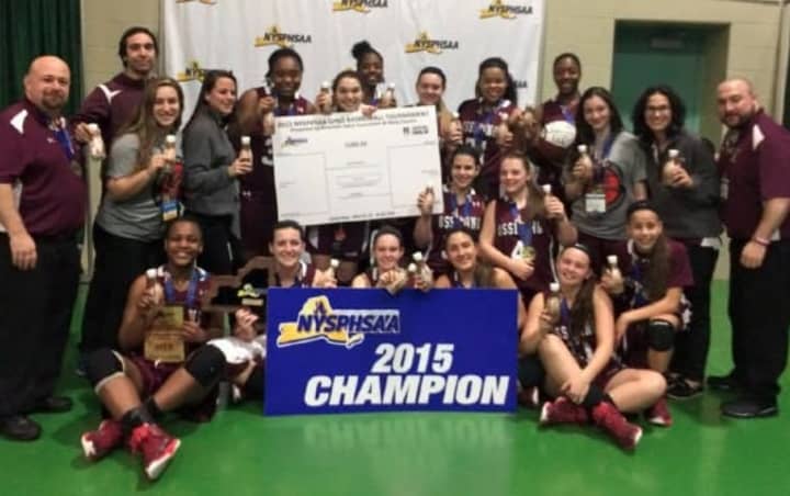Ossining&#x27;s varsity girls basketball team celebrates a third straight state title.