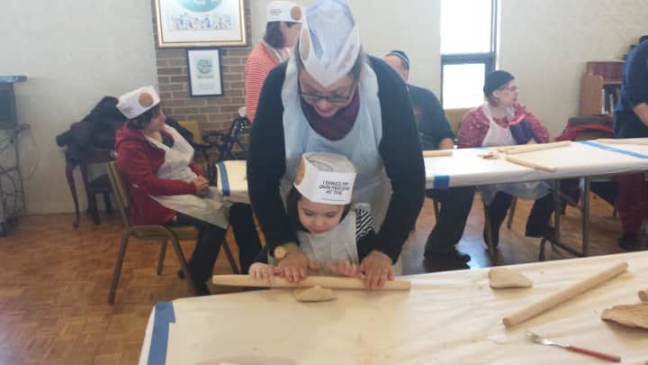 Yonkers residents, Iris and her daughter Emily are having fun rolling the dough for their very own matzoh.