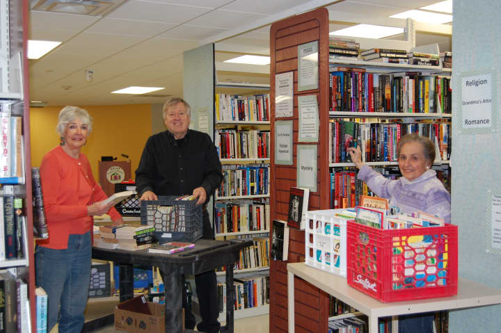 Kaye Baum, Richard Harrison and Phyllis Briggs sort books for the upcoming Kent Library book sale.