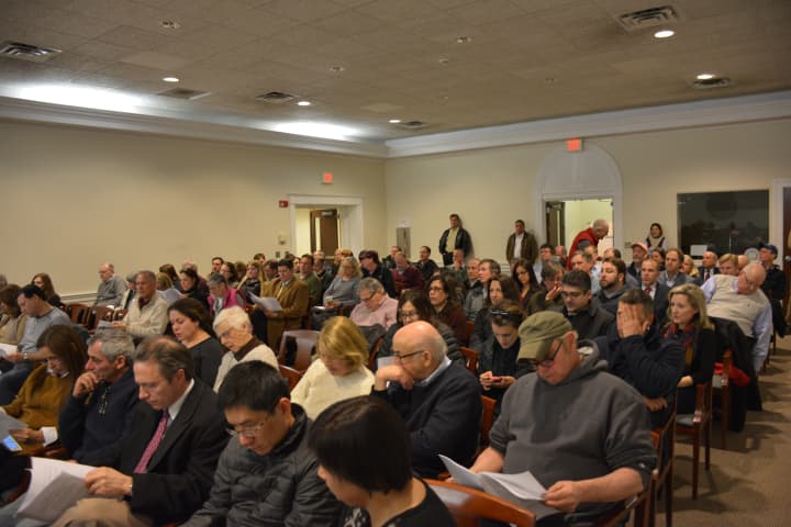 A packed crowd attends a meeting on a scoping session for the 79-home proposed development in Bedford Village.