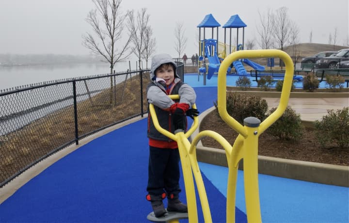 Five-year-old Mason Avery of Greenwich checks out the playground equipment at the new Cos Cob Park.