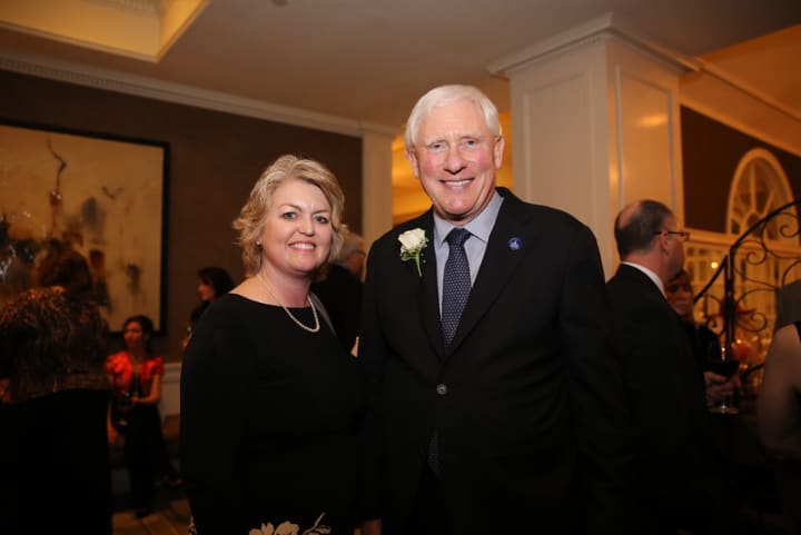 Kim Morgan of the United Way, left, meets Lifetime Hero award recipient James Schmotter, the retiring President of Western Connecticut State University.