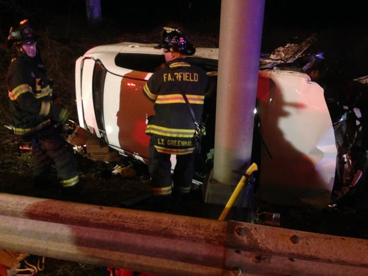 Fairfield and Westport firefighters work together to help victims in a car rollover on I-95. 