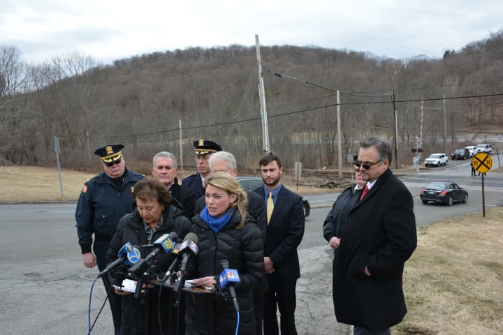 Officials gather for a grade-crossing safety press conference in Chappaqua. The nearby crossing is in the distance.