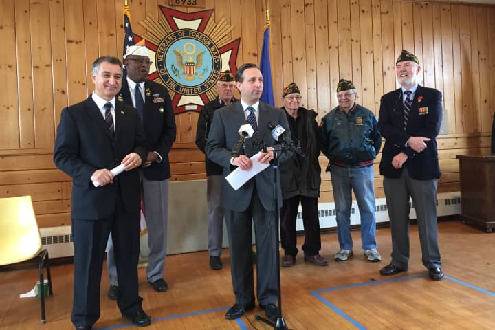 Senators Carlo Leone and Bob Duff, surrounded by veterans at the Darien VFW, announce a bill that would provide 100 percent exemptions on income tax for veterans.