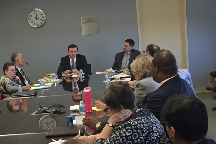 Sen. Chris Murphy sits with mental health professionals from around Fairfield County to discuss new legislation he is crafting to improve the country&#x27;s mental health system.