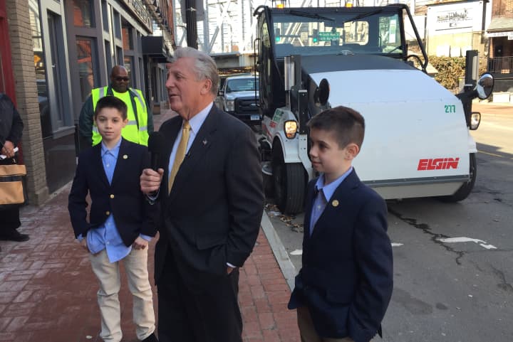 Mayor Harry Rilling, along with temporary Assistant Mayors Aidan and Dylan Dawson, announces a new street sweeping initiative to clean up the city.