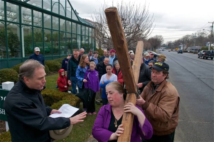 The walkers pause with the cross as the march through Darien to commemorate Good Friday.