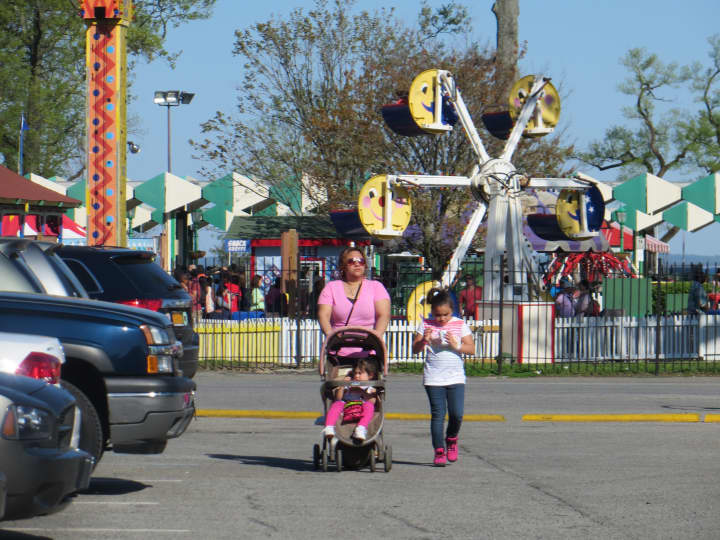 A mother and her two children leave Playland on opening weekend in May 2014.