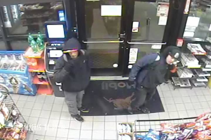 Surveillance footage showing two suspects in a Norwalk car burglary where a wallet and credit cards were stolen.