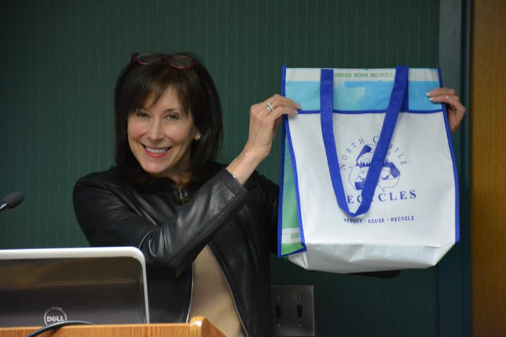 Beth Pollack, co-chair of North Castle&#x27;s Recycling Committee, holds up a reusable bag at a recent Town Board meeting.