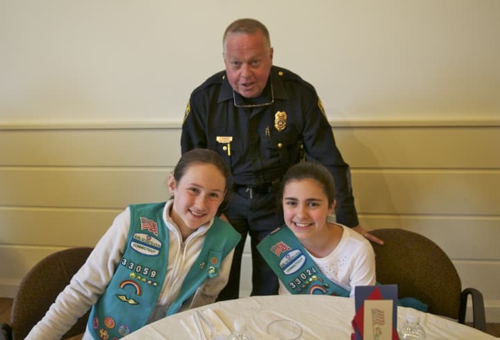 Fairfield Police Department Capt. Joshua S. Zabin enjoys lunch with Scouts Zoe Feay (L) and Emma Fekete.
