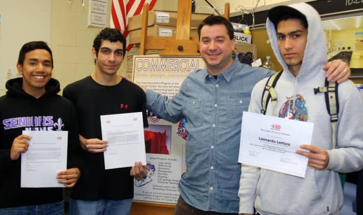 From left, Anthony Duque, Michael Renda and Leo Lertora with their eSchoolData contest certificates in hand, along with BOCES commercial art teacher Damian Powers, center.  