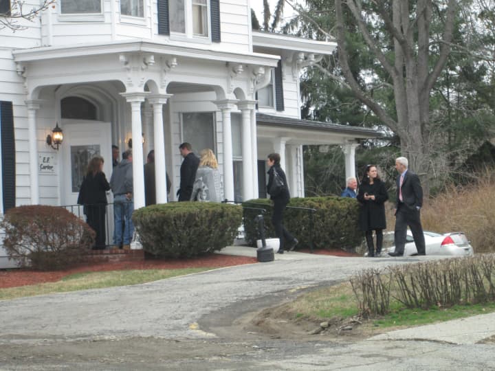 Mourners proceed into the funeral home for the wake of Lacey Carr. 