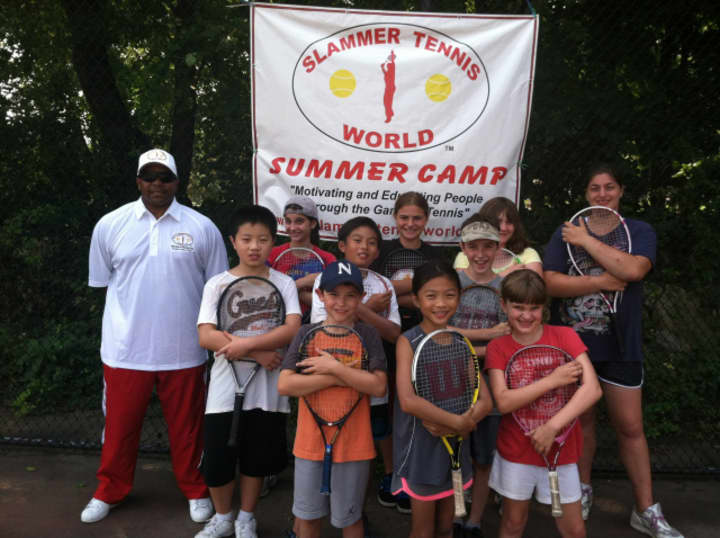 Marvin Tyler, back row, left, of Slammer Tennis World is registering children and adults for spring and summer programs in Norwalk.